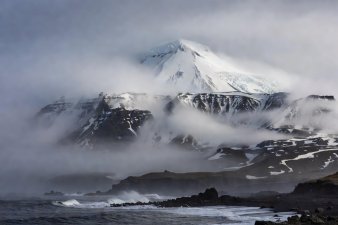 The Beerenberg volcano towering through Atlantic sea fog on Jan Mayen